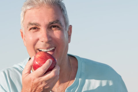 The man eating a apple